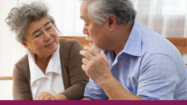 two people sitting and holding hands